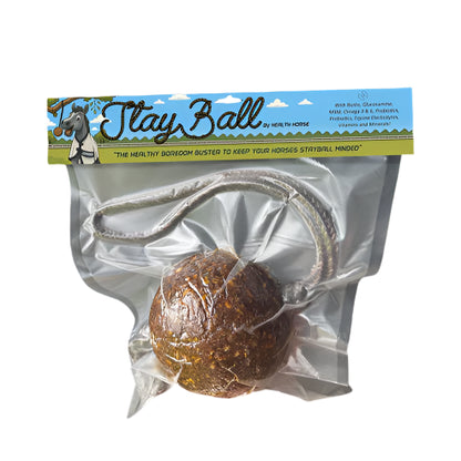 Stay Ball packaging held by a hand with a blurred outdoor background