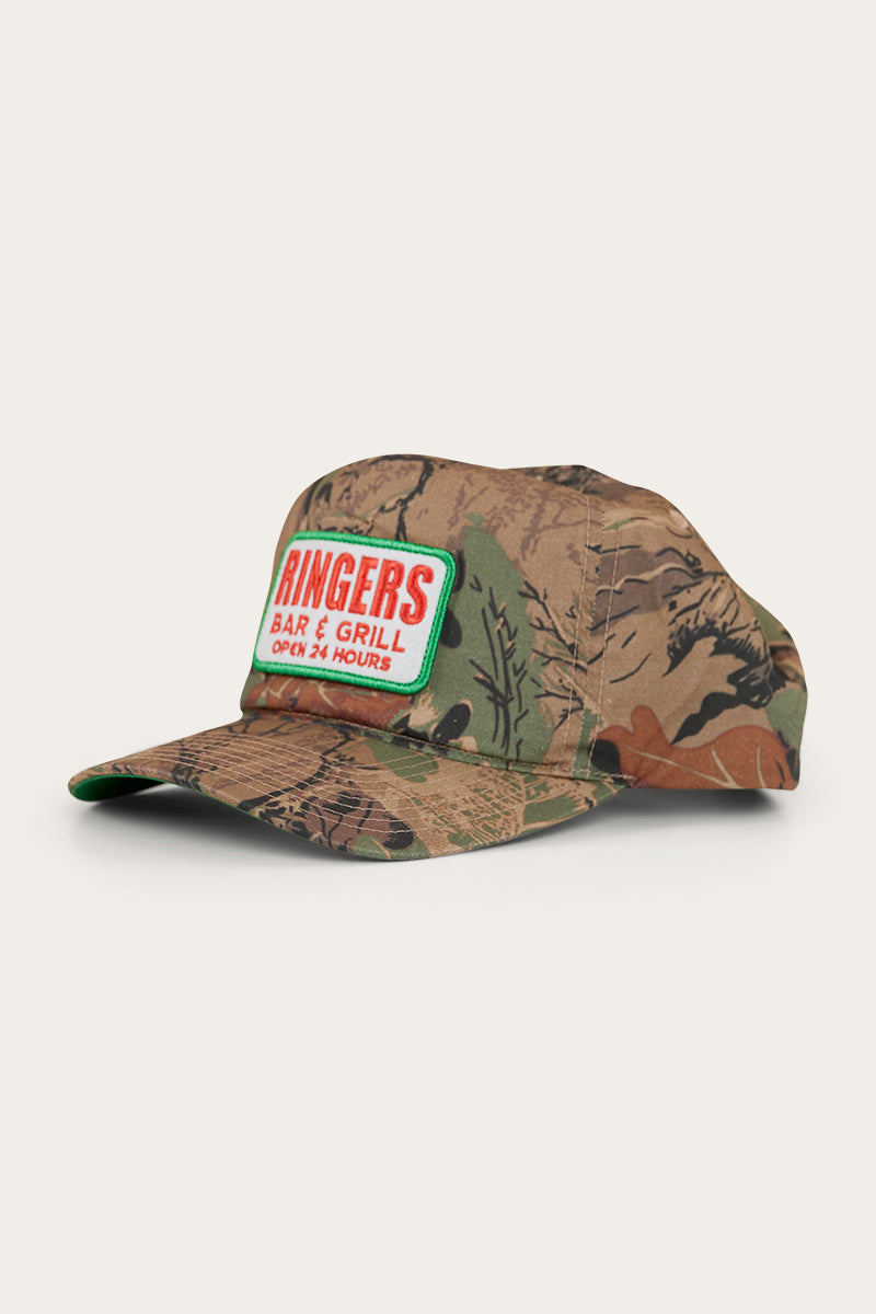 A camouflage cap with an embroidered patch on the front peak and a snapback closure.